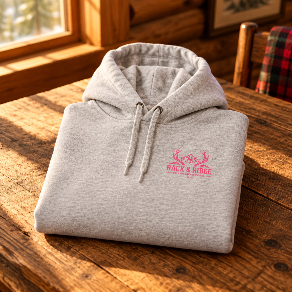 A light heather gray pullover hoodie with a small pink chest graphic 