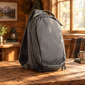 Gray backpack with a brand logo on a white background